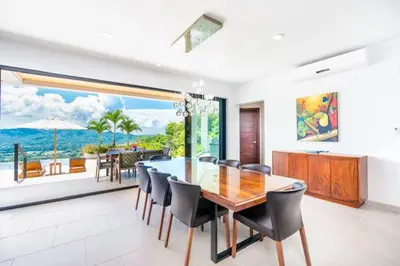 a dining room with a table and chairs with a view at Infinity Pool Haven, Ocean Views & Concierge in Potrero