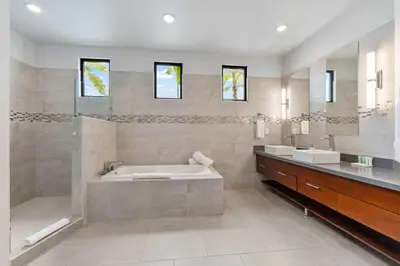 a bathroom with a tub and a shower and a sink at Infinity Pool Haven, Ocean Views & Concierge in Potrero