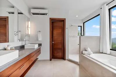 a bathroom with a tub and a sink and a shower at Infinity Pool Haven, Ocean Views & Concierge in Potrero