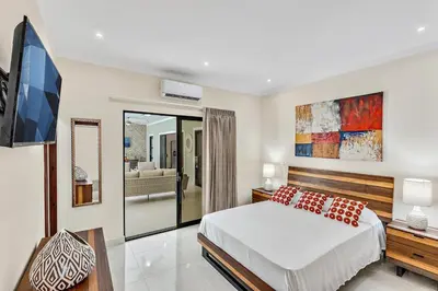 a bedroom with a bed and a flat screen tv at Fun Packed Family Vacation in Playa Flamingo