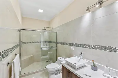a bathroom with a shower and a sink and a toilet at Fun Packed Family Vacation in Playa Flamingo