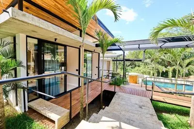 a house with a balcony with a swimming pool at Buho Vibe Earthy Elegance in Tamarindo