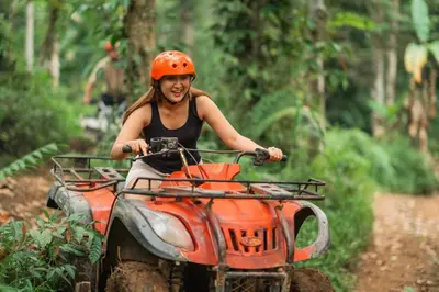 a woman riding a atv down a dirt trail at Buho Vibe Earthy Elegance in Tamarindo