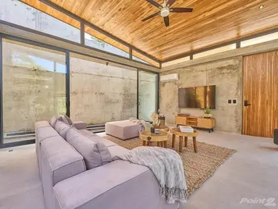 a large living room with a couch and a tv at Buho Vibe Earthy Elegance in Tamarindo