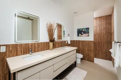 a bathroom with a sink and a mirror and a toilet at Exclusive Villa in Mar Vista Community in Playa Flamingo
