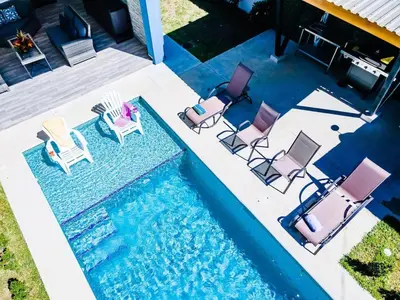 an overhead view of chairs and a swimming pool at Private Pool Ping-Pong Table Walk to Beach Villa in Playa Flamingo