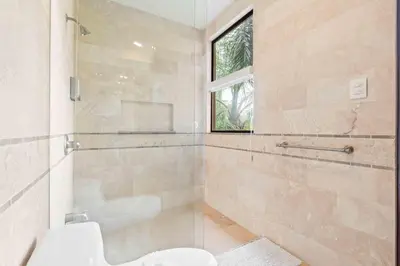a bathroom with a toilet and a sink and a window at Hilltop Haven with Pool, Terrace and Sea Breeze in Ocotal