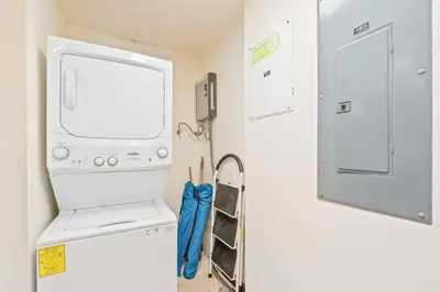 a room with a washer and dryer next to a door at Hilltop Haven with Pool, Terrace and Sea Breeze in Ocotal