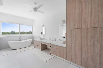 a bathroom with a tub and two sinks and a window at Modern Villa 5 BD 4 BA Large Pool in Playa Avellana
