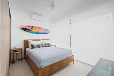 a bedroom with a bed and a painting on the wall at Modern Villa 5 BD 4 BA Large Pool in Playa Avellana