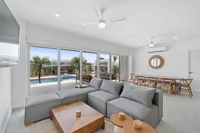 a living room with a couch and a table at Modern Villa 5 BD 4 BA Large Pool in Playa Avellana