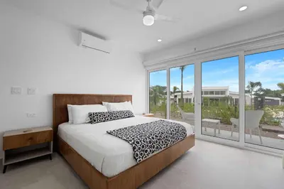 a bedroom with a bed and a large window at Modern Villa 5 BD 4 BA Large Pool in Playa Avellana