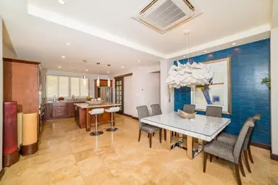 a kitchen and dining room with a table and chairs at Captivating Ocean Views Condo with Pool in Ocotal