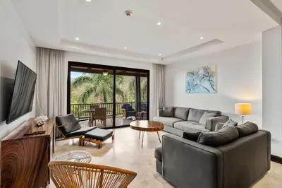 a living room with a couch and a table and chairs at Spacious 4 Bedroom Condo Pool in Ocotal