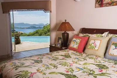 a bedroom with a bed with a view of the ocean at Luxury Villa, Infinity Pool & Ocean Views in Potrero