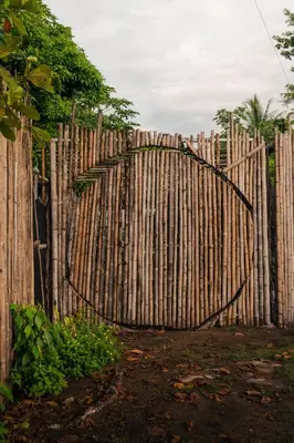 a wooden fence with a tree in front of it at Bambuk Bio Chalet Uvita Beach Front in Uvita