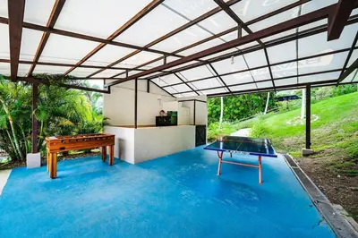 a room with a ping pong table and a ping pong table at Spacious Villa Retreat in Private Resort in Playa Hermosa