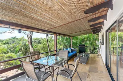 a patio with a table and chairs and a couch at Spacious Villa Retreat in Private Resort in Playa Hermosa