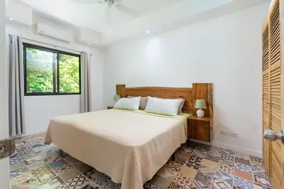 a bedroom with a bed and a window at Pool Paradise Steps from Beach & Restaurants in Playa Flamingo