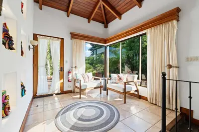a living room with a table and chairs and large windows at Spectacular Ocean Views Infinity Pool in Potrero