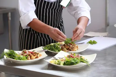 a chef preparing plates of food on a counter at Spacious Villa with Infinity Pool & Ocean View in Potrero