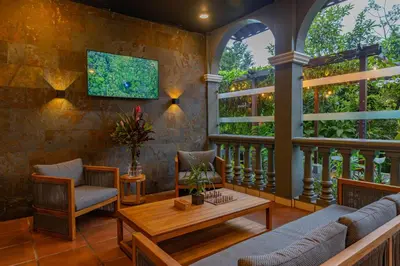 a living room with a couch and a table at Tifakara by the Waterfall in Fortuna