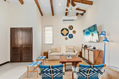 a living room with a couch and a table and chairs at Stylish Condo in the Heart of Las Catalinas with Vibrant Design & Exclusive Beach Club Access in Playa Danta