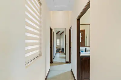 a hallway of a house with white walls at Stylish Condo in the Heart of Las Catalinas with Vibrant Design & Exclusive Beach Club Access in Playa Danta