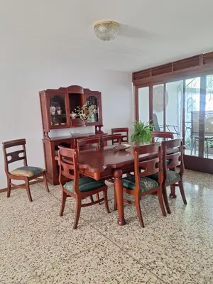 a dining room with a wooden table and chairs at Linda y céntrica habitación in Alajuela City