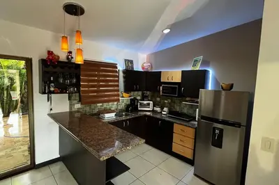 a kitchen with a stainless steel refrigerator and a counter at Hermosa Casa con todos los servicios a la mano in Barrancas