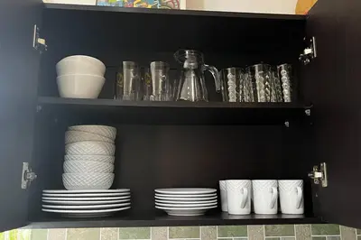 a black shelf with plates and cups and dishes at Hermosa Casa con todos los servicios a la mano in Barrancas