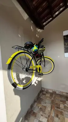 a yellow bike is hanging on a wall at Hermosa Casa con todos los servicios a la mano in Barrancas