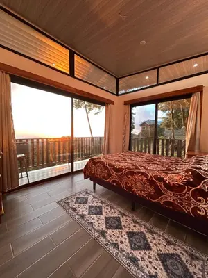 a bedroom with a bed and a large window at Athila Ecolove in Monteverde Costa Rica
