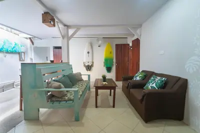 a living room with a couch and a chair at The Cafecito Surfhouse - Santa Teresa in Santa Teresa Beach