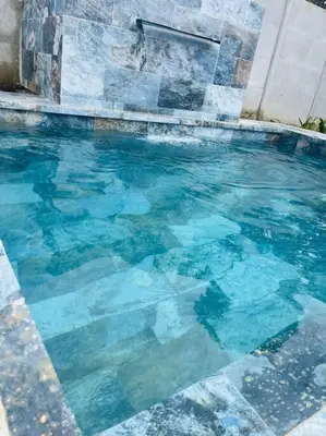 a swimming pool with blue water in a building at Lisas Loft with Great view and new pool in Fortuna