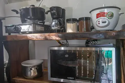 a microwave on top of a wooden shelf at Bamboo Relax Uvita in Uvita
