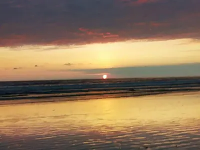 a sunset on a beach with the ocean at Bamboo Relax Uvita in Uvita