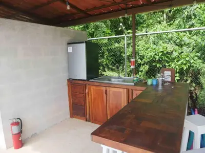 an outdoor kitchen with a counter and a sink at Private Villa with Pool near Manuel Antonio beach in Naranjito