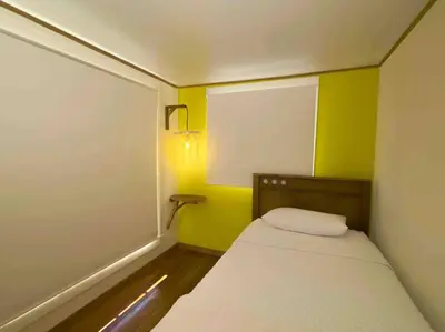 a small room with a bed and a yellow wall at Private Villa with Pool near Manuel Antonio beach in Naranjito