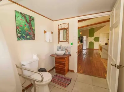 a bathroom with a toilet and a sink at Private Villa with Pool near Manuel Antonio beach in Naranjito