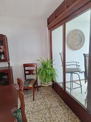 a living room with a table and chairs and a plant at Acogedora y amplia habitación en La Tropicana in Alajuela City