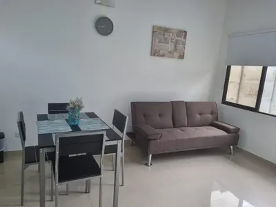 a living room with a couch and a dining room table at Villas Azul in Tamarindo