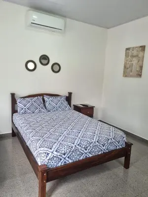 a bedroom with a bed and two plates on the wall at Villas Azul in Tamarindo