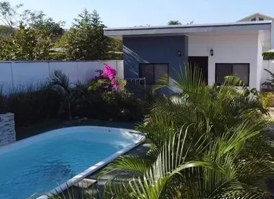 a swimming pool in front of a house at Villas Azul in Tamarindo