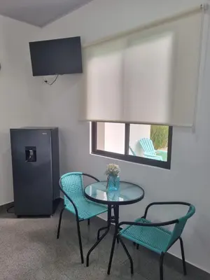 a room with a table and two chairs and a window at Villas Azul in Tamarindo