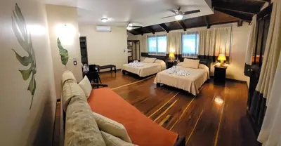 a living room with two beds and a couch at Selva Verde Lodge in Sarapiquí