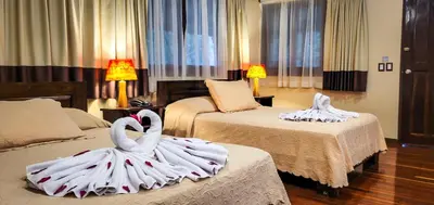 two swans made out of towels on beds in a hotel room at Selva Verde Lodge in Sarapiquí