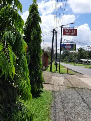 a sign for a hotel on the side of a road at Hotel Boutique Malibu Los Sueños in Tigre