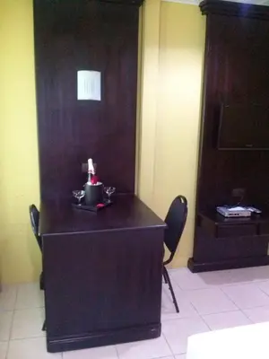 a desk in a room with two chairs and a wall at Hotel Boutique Malibu Los Sueños in Tigre