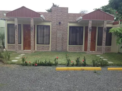 a house with a yellow bench in front of it at Hotel Boutique Malibu Los Sueños in Tigre